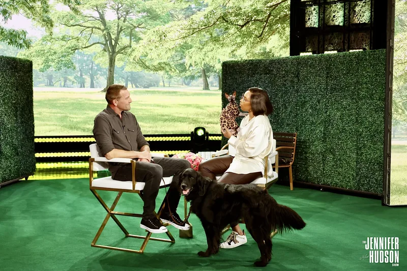 Brandon McMillan and Jennifer Hudson seated with a dog