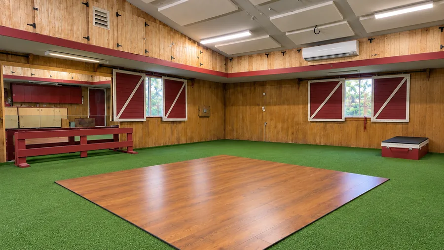 Indoor training room with turf and a wood platform